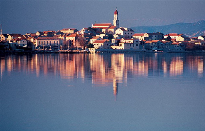 about-03 image  View of Betina with the church of St. Francis from the sea